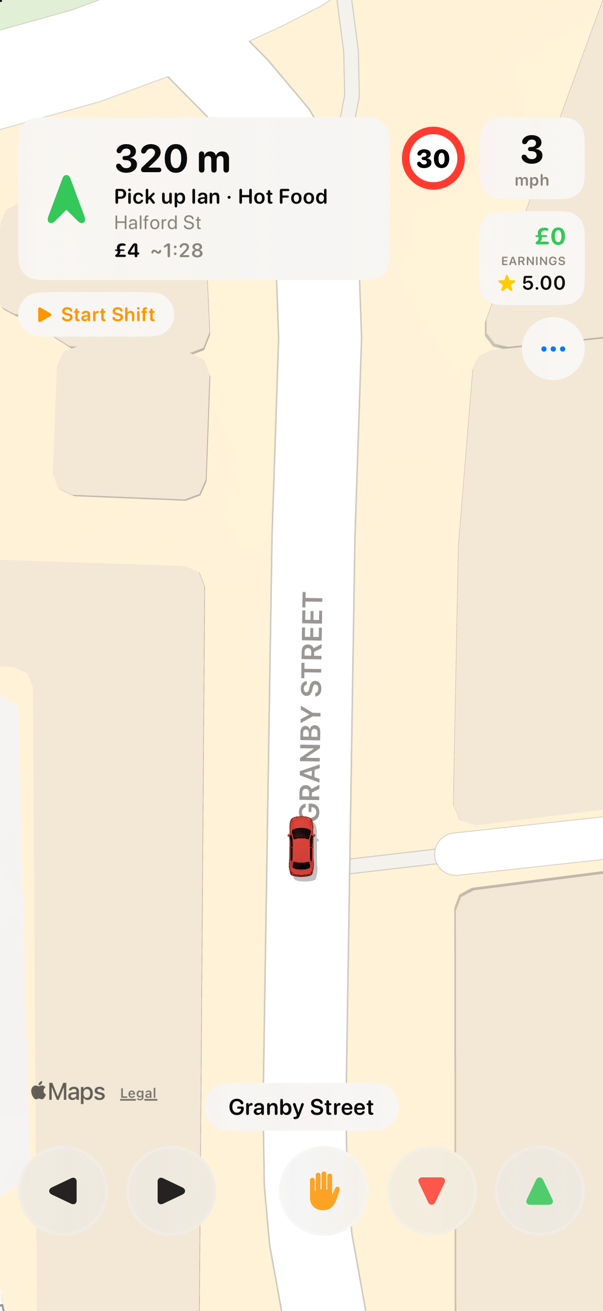 Top-down gameplay: the taxi on a real city street, heading for a rider waiting at a green pickup marker
